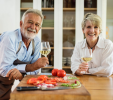 couple in their 50's drinking wine in a kitchen