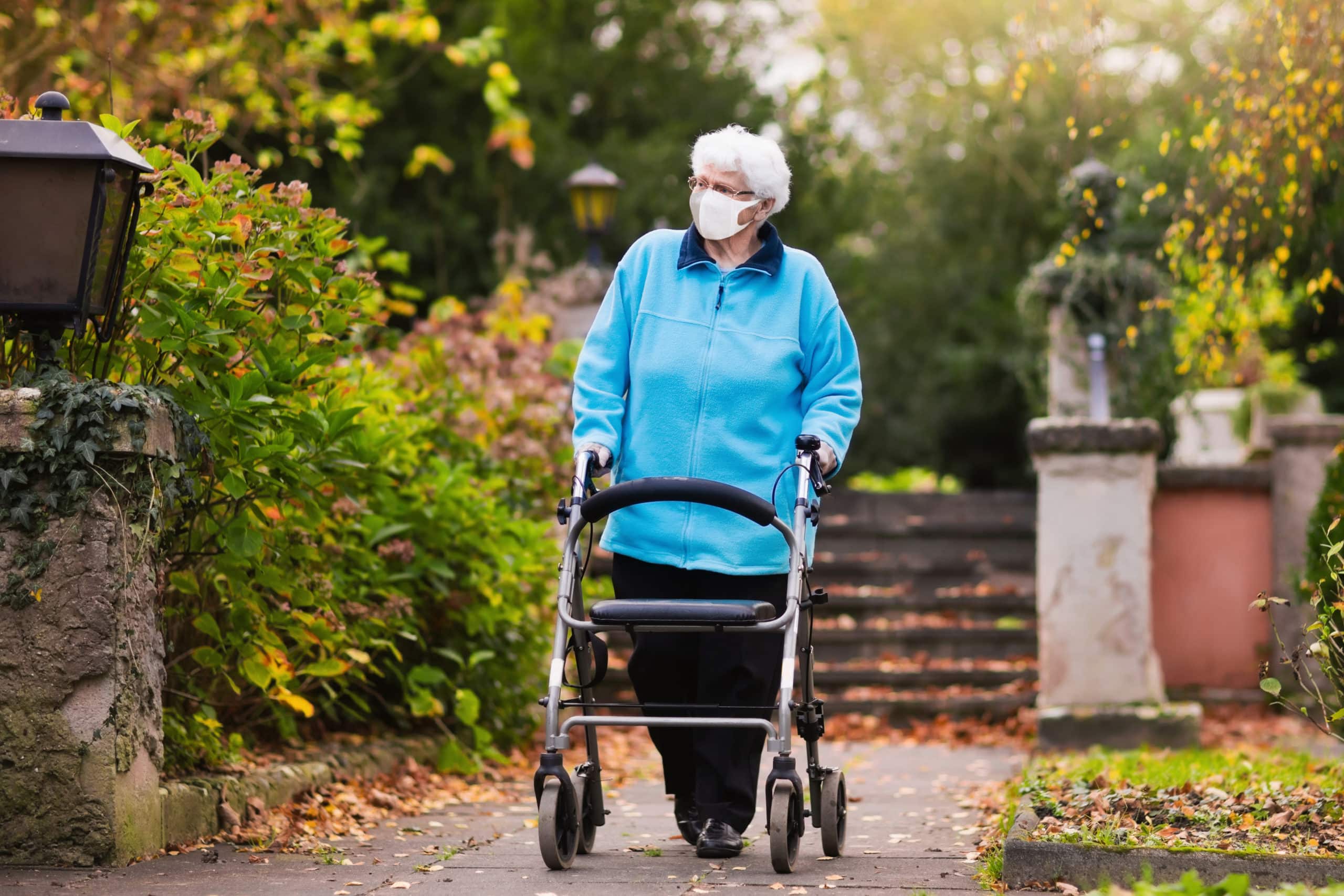 Handicapped Lady Wearing Face Mask With A Walker